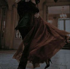 a man and woman are dancing in an old building