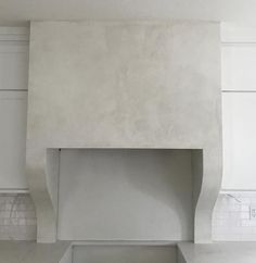 a white kitchen with an oven and counter top in the center, surrounded by cabinets