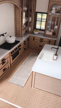 a model kitchen with wooden cabinets and white counter tops, including a stove top oven