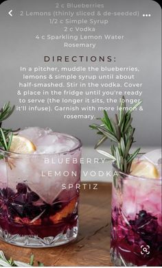 two glasses filled with purple lemonade and rosemary spritz on top of a wooden table