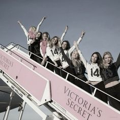 a group of women standing on top of a roller coaster