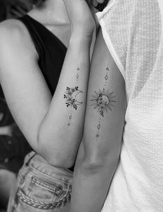 two people with tattoos on their arms and one is holding the other's arm