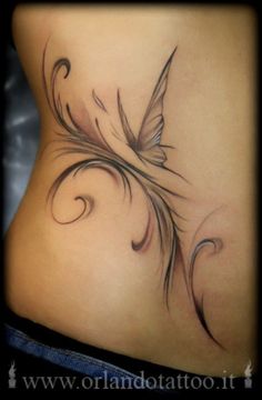 a woman's stomach with an artistic tattoo design on the side and bottom part