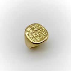 This 18k gold Tiffany & Co. Larter & Sons signet ring is hand carved with a heraldic family crest. The crest has a shield with three bell-like shapes sprouting flowers. Above the shield is a knight’s helmet topped with a feather and surrounded by scrolling foliate. The classic design of the crest suggests royalty and valor.  Larter & Sons was founded in 1865 and was renowned for their exquisite craftsmanship of men’s accessories. They expanded to include women’s jewelry in the early 20th century, using intricate techniques such as guilloche and enamelwork, and incorporating motifs inspired by nature. They collaborated with Tiffany & Co. to make jewelry such as cufflinks and signet rings. Tiffany & Co. would often consign well-known brands of the highest quality, including Larter & Sons. Luxury Carved Yellow Gold Signet Ring, Classic Yellow Gold Engraved Ring With Coat Of Arms, Gold Oval Signet Ring With Coat Of Arms, Formal Gold Signet Ring With Coat Of Arms, Luxury 14k Gold Signet Ring With Intaglio, Classic Ceremonial Signet Ring With Intaglio, Luxury Ceremonial Engraved Signet Ring, Symbolic Yellow Gold Hallmarked Signet Ring, Classic Gold Signet Ring With Intaglio