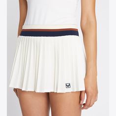 Our best-selling Pleated Tennis Skirt is updated with a mini silhouette. Lightweight and breathable, the classic design is also moisture wicking with great stretch and recovery. A striped elastic waistband and built-in boy short ensure comfort and ease of movement. White Pleated Sports Bottoms, White Athleisure Pleated Skirt Bottoms, White Pleated Skirt Bottoms In Athleisure Style, White Athleisure Mini Skirt, White Pleated Sporty Shorts, Striped Fitted Short Length Skort, Sporty White Pleated Shorts, Sporty White Mini Skirt With Elastic Waistband, Sporty Pleated Shorts