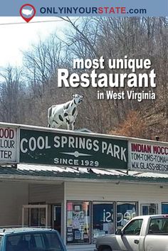 the front of a restaurant with cars parked in front of it and an advertisement on the roof that says cool springs park