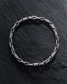 Introducing the Silver Bracelet TID ROM, a piece that encapsulates the essence of "time and space" in its design. The name itself, where "Tid" translates to "time" in Scandinavian languages and "Rom" signifies "space" or "free space", embodies the notion of striking a balance between the dynamic flow of time and the serene expanse of space in our lives. More than just an accessory, the TID ROM bracelet serves as a poignant reminder of the importance of carving out time for oneself and cherishing Sterling Silver Box Chain Bangle, Sterling Silver Box Chain Bangle Bracelet, Silver Bracelets With Rectangular Links And Sterling Clasp, Modern Silver Link Bracelet, Modern Silver Bracelet With Hook And Links, Sterling Silver Bracelet With Hook And Links, Silver Bangle Bracelet With Solid Link Construction, White Gold Sterling Silver Bracelet With Hooks And Links, Link Bracelet With Sterling Silver Clasp