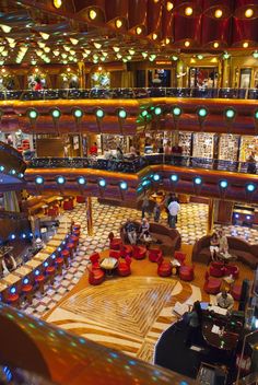 the inside of a cruise ship with many lights