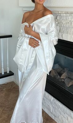 This shimmery white silky floor-length robe is the perfect staple piece to own. A smooth belt drapes around to tie at the front, wrapping the fabric up softly. With a crisp neckline and wide sleeves, this kimono robe can be worn to lounge around comfortably, as a bridal robe, or to add a luxurious touch to relax in Bridal Robe, Bridal Robes, Wide Sleeves, Staple Pieces, Floor Length, Off Shoulder Dress, Lounge, Fabric, White