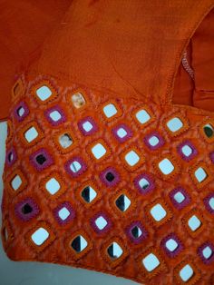 an orange piece of cloth with small squares on it