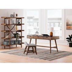 a wooden desk sitting on top of a hard wood floor next to a book shelf