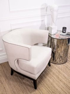 a white chair sitting on top of a hard wood floor