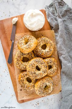 bagels on a cutting board with cream cheese