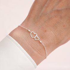 "Handcrafted 925 Sterling Silver Infinity Heart Bracelet.  Each bracelet features a delicate double heart charm, designed to symbolize the unbreakable bond and infinity love shared between best friends or loved ones. This dainty and stylish piece is perfect for adding a touch of sophistication to any outfit. Whether you're looking for a sentimental gift or a beautiful addition to your jewellry collection. DETAILS: * Material: Premium 925 Sterling Silver * Handmade with care, presented in an eco-friendly box * Adjustable sizes: Regular  7\" / 17cm Large     8\" / 20cm    🎁 It could be a thoughtful gift for a best friend or partner to represent love and connection.    To explore more love bracelets visit: https://www.etsy.com/uk/shop/CrystalJewelsOasis?ref=seller-platform-mcnav&search_query Minimalist Sterling Silver Heart Bracelet For Mother's Day, Silver Double Heart Bracelets For Mother's Day, Elegant Double Heart Sterling Silver Bracelet, Double Heart Bracelet For Mother's Day, Sterling Silver Friendship Bracelets For Valentine's Day, Sterling Silver Heart Bracelet For Mother's Day And Friendship, Sterling Silver Heart Bracelet For Anniversary And Mother's Day, Dainty Sterling Silver Bracelets For Valentine's Day, Sterling Silver Heart Bracelet For Anniversary On Mother's Day