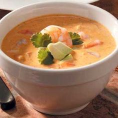 a white bowl filled with soup and garnished with cilantro