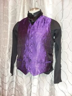 "This is a modern styled formal vest, with  a collarless  \"V\" neck, and peaked front hem. The front is silk brocade with a woven purple and black pattern.  Back is a solid black satin. Vest has 2 functioning pockets, and adjustable back belt, and is fully lined. For buttons, you have 2 options -  self covered to match, or a purple \"jeweled\" button We specialize in making Big and Tall sizes, email us for more info." Elegant Fitted Vest For Costume Party, Elegant Fitted Vest For Costume, Black Elegant Vest For Costume, Elegant Black Vest For Costume Party, Elegant Black Vest For Costume, Black And Purple Tuxedo, Elegant Satin Vest For Formal Occasions, Black Tux With Purple Accents, Purple Victorian Suit Men