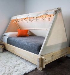 a bed that is made out of wood and has lights on the top of it