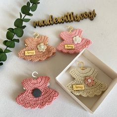 crocheted baby shoes and name tags are on display next to a box that says made with love