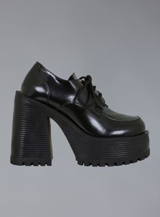 The Des Shoe is our all new stacked oxford with a platform rubber sole and heel. Round laces and a platform that measures 1.5" in the front and 4.5" at the heel! Also available in a matte leather.  ﻿ Shoes are listed in U.S. Women's sizes. Fit is true but we recommend that if you normally wear a half size you should si Platform Oxfords, Unif Des Shoe, Black Platform Oxford Shoes, Black Synthetic Platform Lace-up Shoes, Black Lace-up Shoes With Chunky Platform And Round Toe, Black Lace-up Platform Leather Shoes, Black Leather Platform Oxfords, Unif Shoes, Oxford Platform Shoes