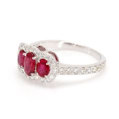 Classic ruby 3-stone ring in 14 karat white gold. This ring is prong set with three 1.30cttw red oval shaped ruby corundum, and 42 diamonds weighing 0.52cttw. Ring Size 7. Ruby Is The Birth Stone For July. Silver Ruby Ring With Three Stones In Oval Shape, Heirloom Ruby Three-stone Ring, Red Three-stone Ruby Ring, Luxury Oval Three-stone Ruby Ring, Antique Three-stone Ruby Ring Gift, 3 Stone Ring, 3 Stone Rings, Ring Size 7, Stone Ring