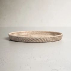 a round wicker tray on a white surface with no one around it or in the background