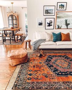 a living room filled with lots of furniture and pictures on the wall above it's couch