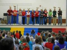 a group of people standing on top of a stage in front of a large crowd