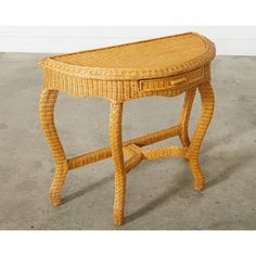 a wicker table with drawers on the top is shown in an empty room and has concrete flooring