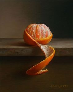 an orange sliced in half sitting on top of a table