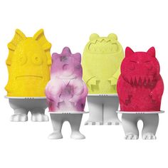 three different colored monster shaped objects in front of white background