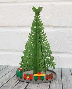 a paper christmas tree on a wooden table