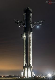 the space shuttle is lit up at night with lights on it's top and bottom