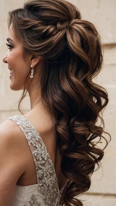 a woman with long brown hair wearing a wedding hairstyle and an intricate braid in her hair