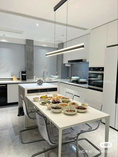 a table with plates of food on it in a kitchen