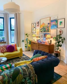 a living room filled with lots of furniture and decor on top of a hard wood floor