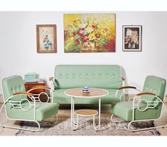 a living room filled with furniture and pictures on the wall