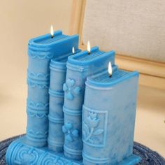 three blue candles sitting on top of a table