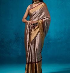 This beautiful Chanderi saree, with a striking combination of golden and silver metallic hues and red stripes, offers a perfect blend of traditional and modern aesthetics. ✨ . The luxurious shine and bold accents make it a statement piece for any occasion. The blouse can be stitched with an additional cost. This saree is 100% original and pure, ensuring authenticity and premium quality.🌟 Don't just wear a saree; own the spotlight with Poonam Sarees! 💫🛍️ #SareeStar #GlamInSilk Fabric: Pure Sil Festive Silver Pre-draped Saree With Unstitched Blouse, Traditional Silver Tissue Silk Pre-draped Saree, Traditional Silver Pre-draped Saree With Pallu, Silver Pre-draped Saree With Zari Work For Festive Occasion, Silver Bollywood Pre-draped Saree For Festive Occasions, Festive Silver Bollywood Pre-draped Saree, Silver Pre-draped Saree With Unstitched Blouse For Festive Occasions, Festive Silver Pre-draped Saree, Designer Silver Blouse Piece With Traditional Drape