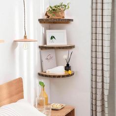 a bedroom with three shelves on the wall