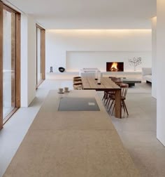 a dining room with a table and chairs next to a fire place