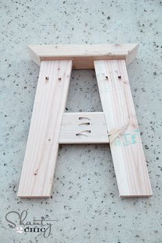 a wooden letter that is sitting on the ground