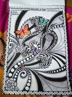 a drawing with butterflies on it sitting on a blanket