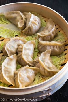 some dumplings are sitting in a basket on the table