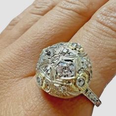 14kt White And Yellow Gold Vintage European Cut Diamond Dome Ring. There Are Two 3.5mm Old Euro Cut Diamonds And 19 Other Old Euro Cut Diamonds On The Ring. The Ring Is Approximately 0.54ctw Of Diamonds (Estimated In Ring). All Diamonds Are Estimated To Be Vs2-Si1 In Clarity And G-H In Color. The Sphere Of The Ring Measures Approximately 15mm In Diameter And Is Raised Approximately 4.59mm High. This Is An Elegant Vintage Engagement Ring Or Cocktail Ring. The Ring Is Size 7.75 And Weighs 4.1grams Platinum Jewelry With Single Cut Diamonds In Gold, Platinum Jewelry With Gold Single Cut Diamonds, Gold Platinum Jewelry With Single Cut Diamonds, Yellow Single Cut Diamond Rings For Anniversary, Yellow Rings With Single Cut Diamonds For Anniversary, Yellow Gold Platinum Diamond Ring With Rose Cut Diamonds, Yellow Gold Platinum Diamond Ring With Rose Cut, Yellow Diamond Round Anniversary Ring, Yellow Diamond Round Ring For Anniversary