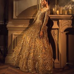 Gold Hand Embellished Lehenga For Wedding, Hand Embellished Gold Lehenga For Wedding, Hand Embellished Bollywood Gown For Formal Events, Bollywood Style Hand Embellished Formal Gown, Formal Hand Embellished Floor-length Lehenga, Bollywood Hand Embellished Formal Gown, Gold Hand Embellished Bollywood Gown, Festive Elegant Gown With Long Train, Elegant Festive Gown With Long Train