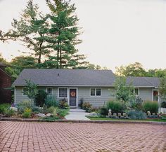 a brick driveway in front of a house