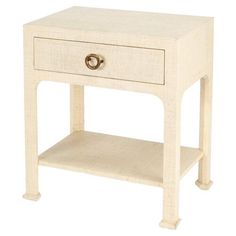 a small white table with a drawer on the bottom and one drawer at the top