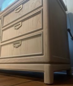 a wooden dresser sitting on top of a hard wood floor