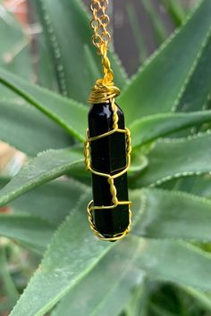 "Beautiful gold wire wrapped Black Agate crystal point pendant on matching chain with lobster claw closure. Other metal colors are available. The pendant is approximately 1.25\" long and 0.4\" wide. Please note that all crystals are unique and therefore color, shape and size may vary slightly. Please choose a necklace length from the drop-down menu. In case you would like a length other than the listed options, leave us a note at checkout. Item will be shipped 2 - 3 business days after purchase. Hand Wrapped Gold Agate Necklaces, Hand Wrapped Gold Agate Necklace, Wire Wrapped Amulet Crystal Pendant Necklace, Wire Wrapped Amulet Pendant Crystal Necklace, Black Wire Wrapped Pendant Crystal Necklaces, Black Wire Wrapped Crystal Pendant Necklace, Black Agate Wire Wrapped Jewelry, Black Wire Wrapped Spiritual Crystal Necklace, Boho Crystal