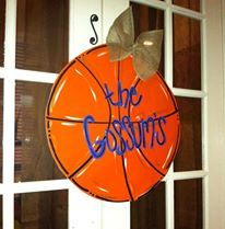 an orange basketball hanging from the side of a white door that says, the cosbys